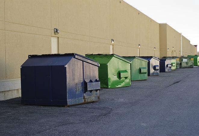 a group of dumpsters lined up along the street ready for use in a large-scale construction project in Accord